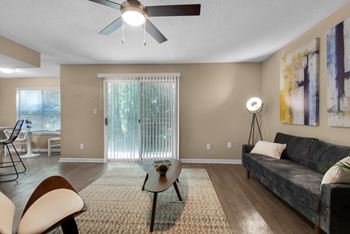 A furnished living room with a ceiling fan.